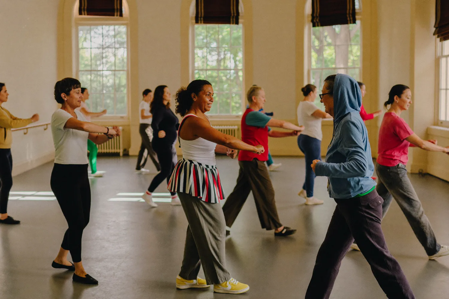 Family salsa dance lesson for all ages in a bright heritage house room in North York