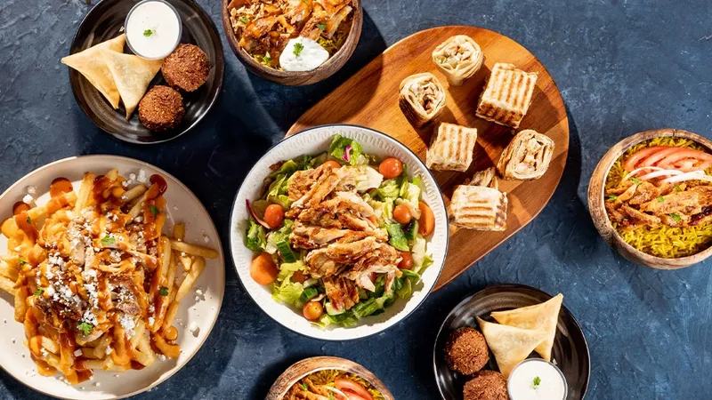 Tahini's menu spread with shawarma bowls wraps and falafel at CF Fairview Mall North York