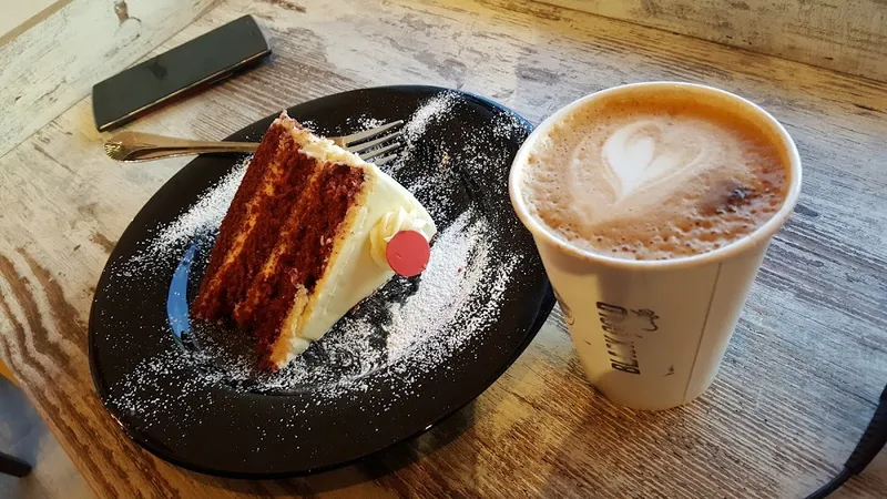 Latte and cake slice at Vanta Coffee Club, North York