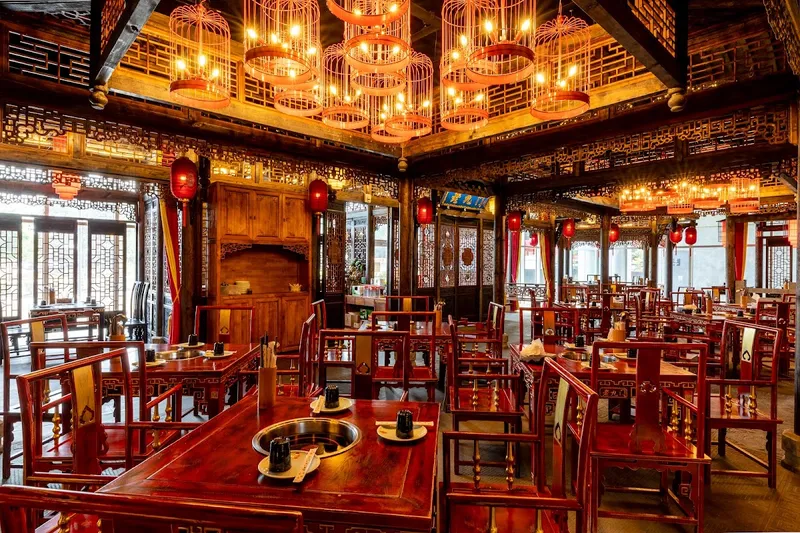 Hotpot 9 Laojiumen ornate traditional Chinese interior with birdcage lanterns and wooden furniture