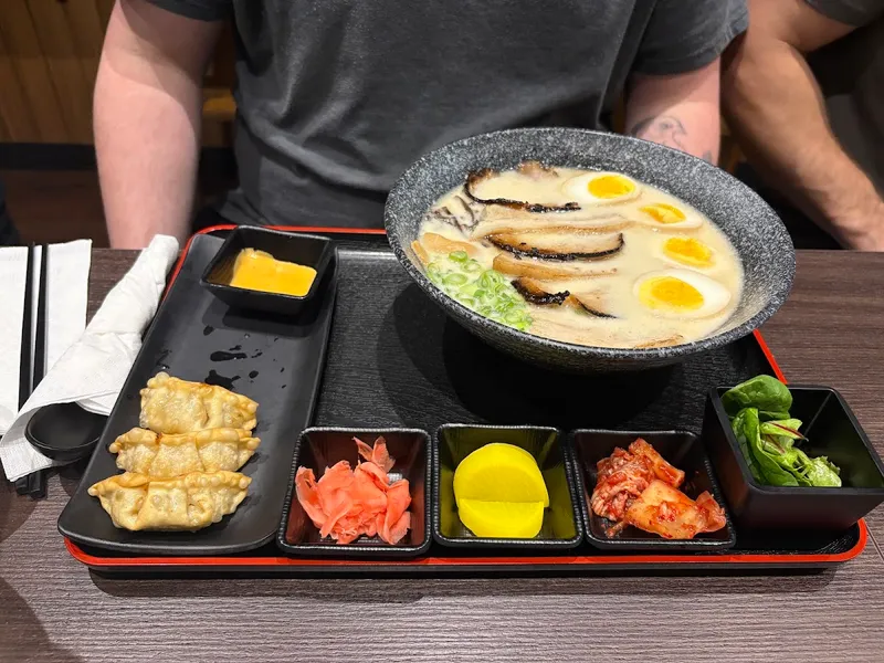 Ikka Ramen tonkotsu bowl with chashu and soft eggs, served with a gyoza set